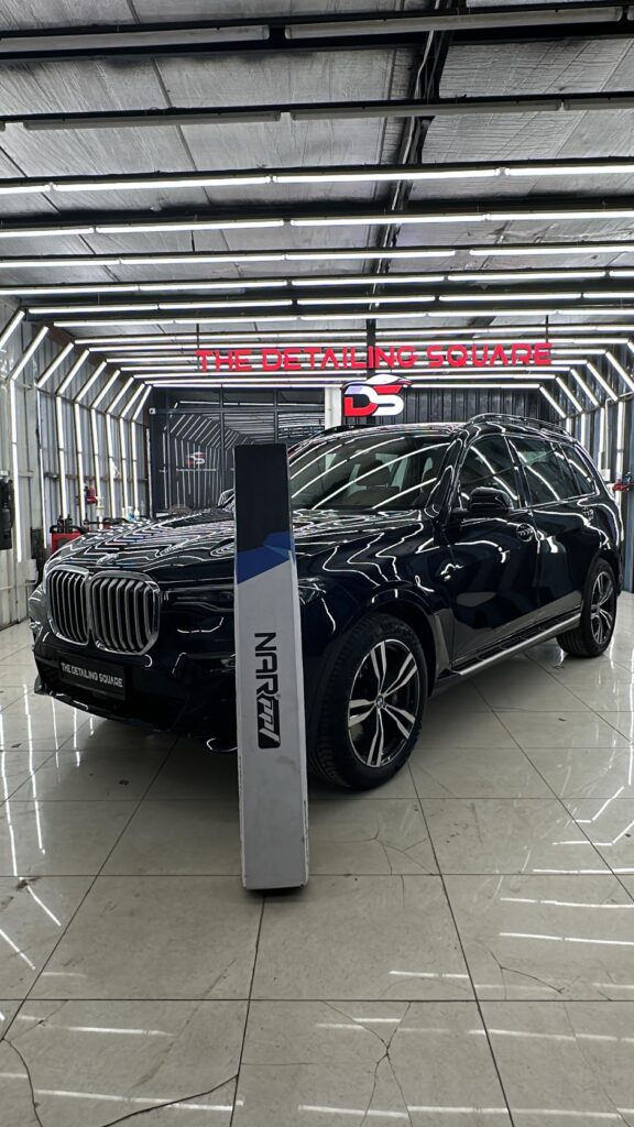Premium car detailing studio showcasing paint protection film installation on a luxury SUV at The Detailing Square