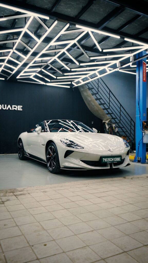 Premium car detailing under LED inspection lighting at The Detailing Square, showcasing high-gloss paint finish and surface clarity.